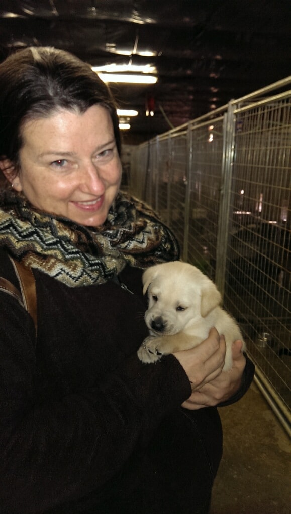 Sherry Bell holding her Labrador retriever Benson